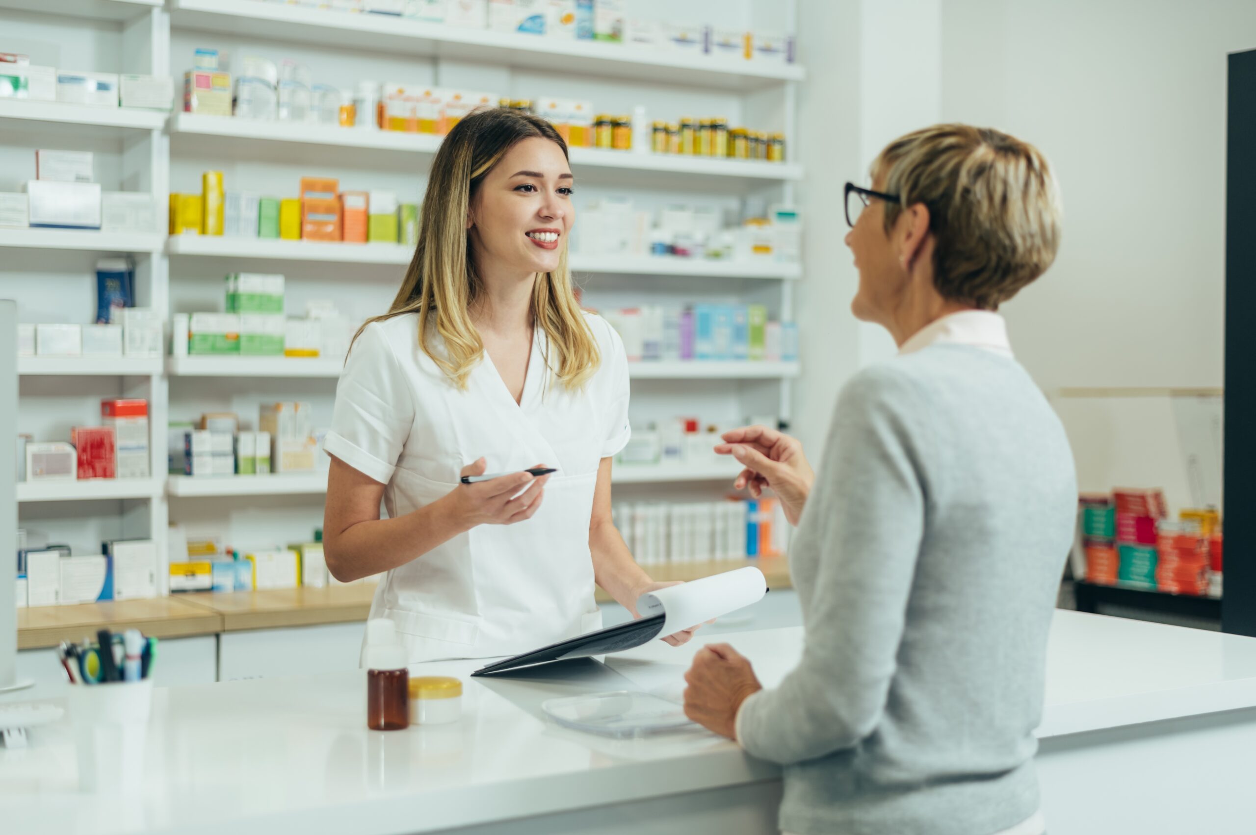 Happy,Senior,Woman,Customer,Buying,Medications,At,Drugstore,While,Talking