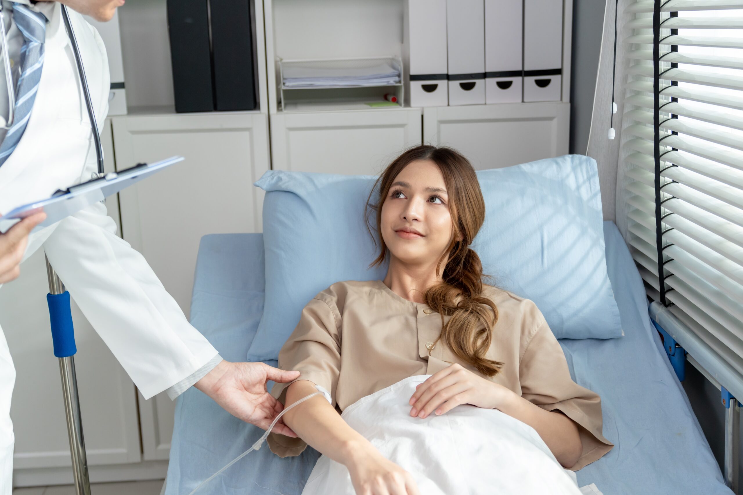 Asian,Young,Female,Patient,Getting,Saline,Solution,In,Hospital,Ward.