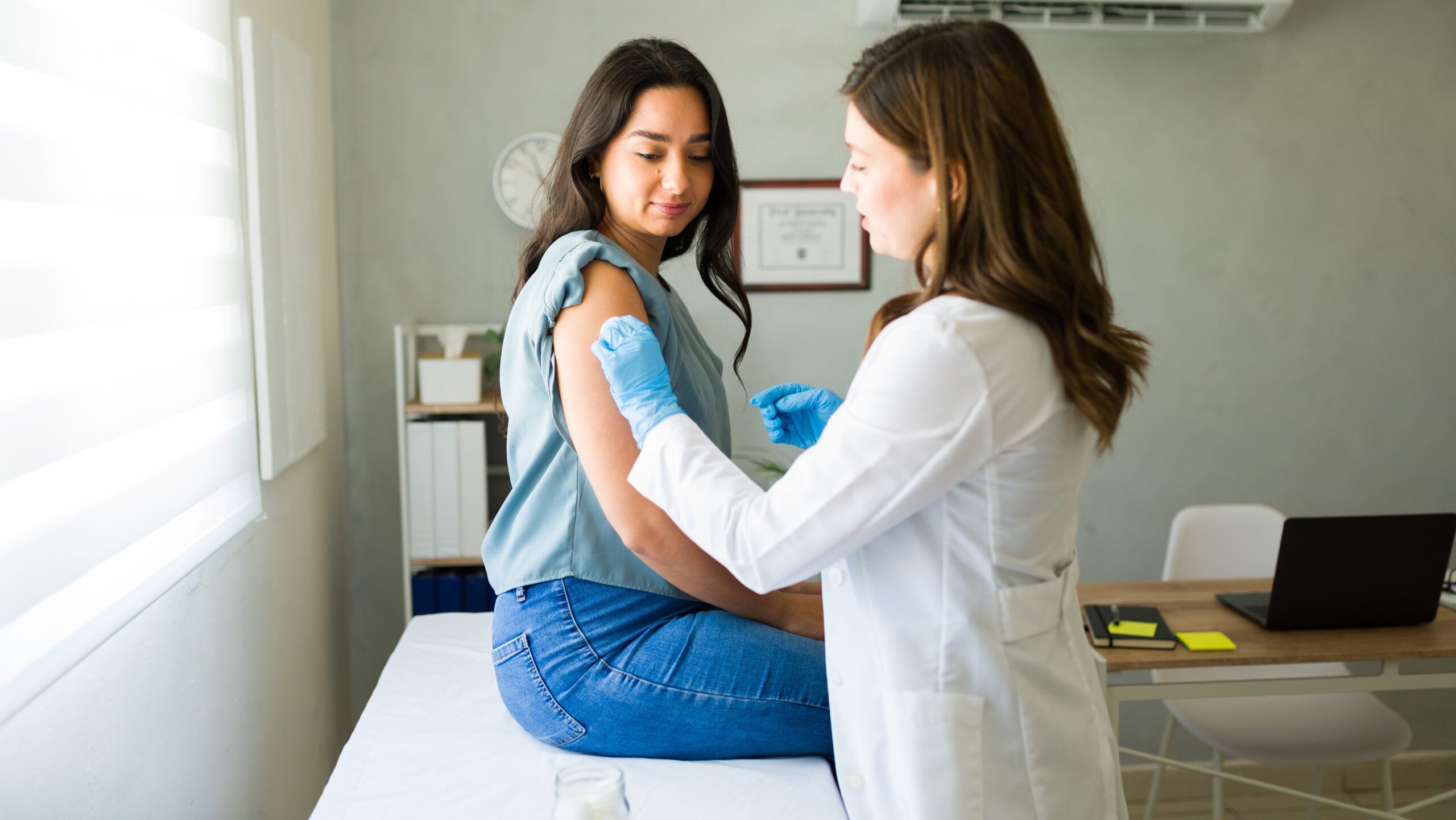 Young,Hispanic,Woman,Is,Getting,Vaccinated,By,A,Professional,Medical